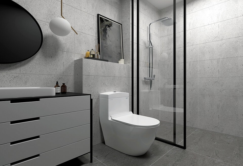 Phòng tắm hiện đại với bồn cầu trắng, tủ gỗ màu đen, vòi sen kính và tường lát gạch màu xám.