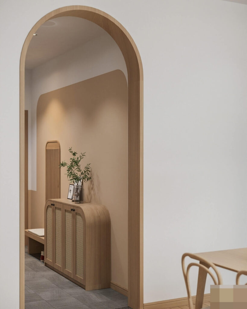 Không gian nội thất phong cách tối giản với cửa vòm gỗ và tủ trang trí cùng bàn ghế gỗ sáng màu.