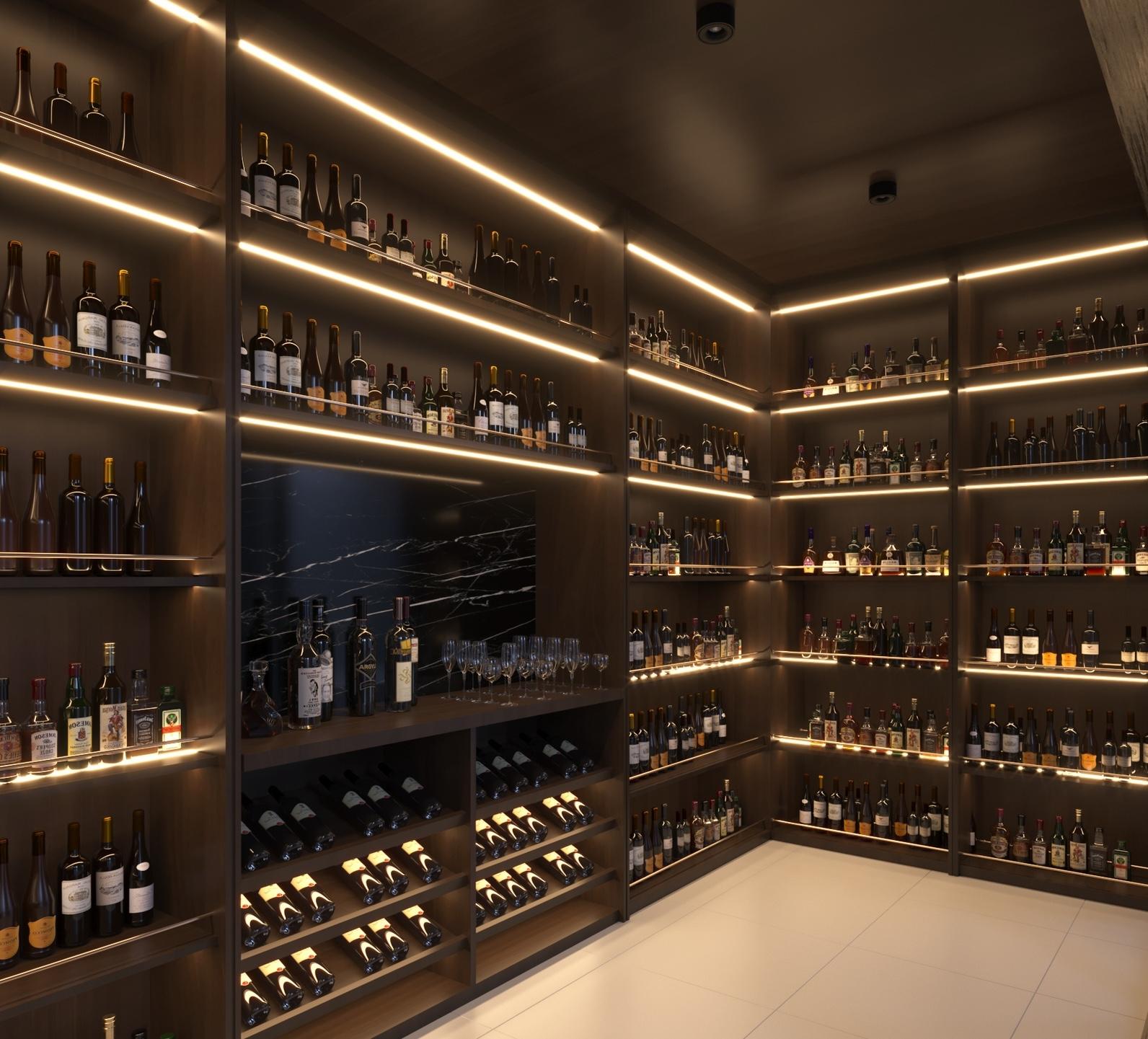Hầm rượu tuyệt đẹp với kệ bày nhiều chai rượu và ly thủy tinh, ánh sáng dịu nhẹ tạo không gian thư giãn.