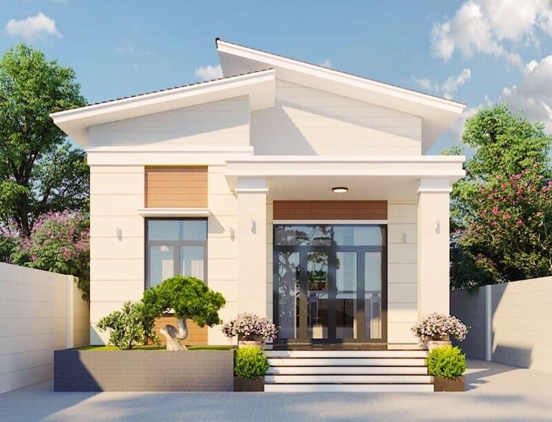 Ngôi nhà một tầng hiện đại với mái dốc, cửa kính lớn và cây xanh xung quanh.