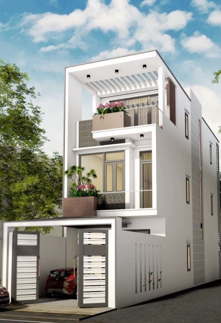 Nhà phố hiện đại ba tầng với gara ô tô, cây xanh trên ban công, trời xanh có mây trắng.