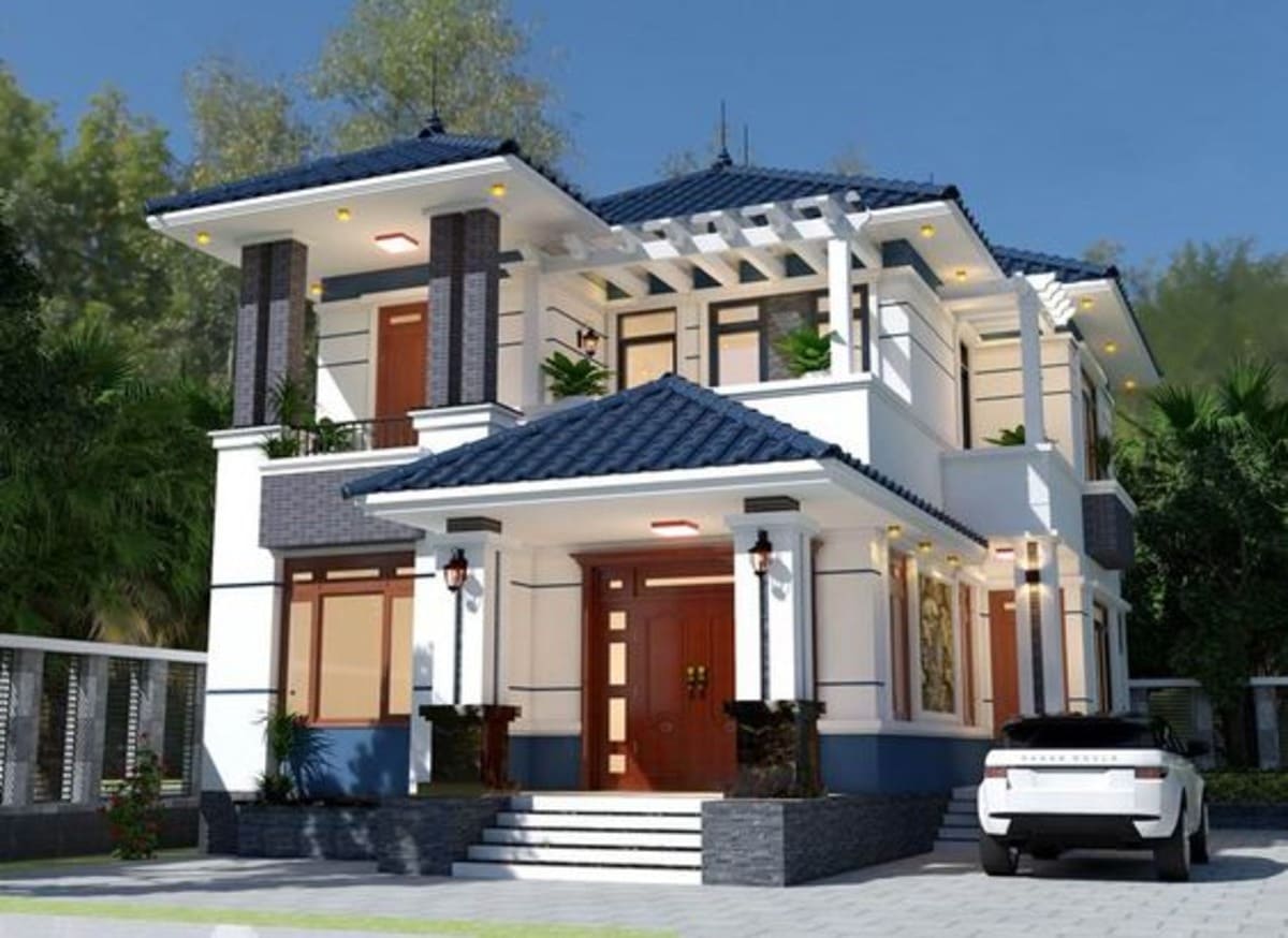 Biệt thự hiện đại hai tầng với mái ngói xanh và xe hơi đỗ trước cửa vào ban ngày.