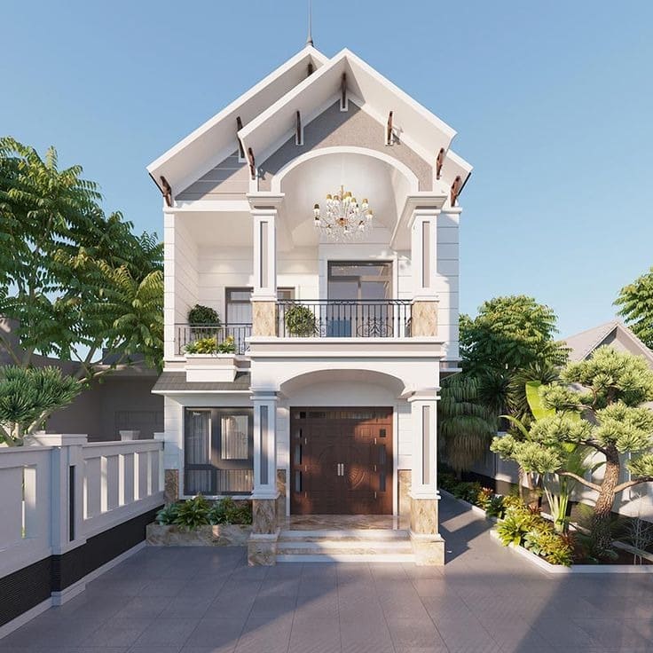 Nhà phố 2 tầng hiện đại, mặt tiền trắng, sân rộng, cây xanh xung quanh, ban công thoáng đãng.