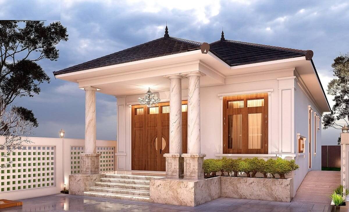 Ngôi nhà hiện đại với mái ngói và cột đá, cửa gỗ lớn, trang trí ánh sáng đẹp mắt vào buổi chiều tối.