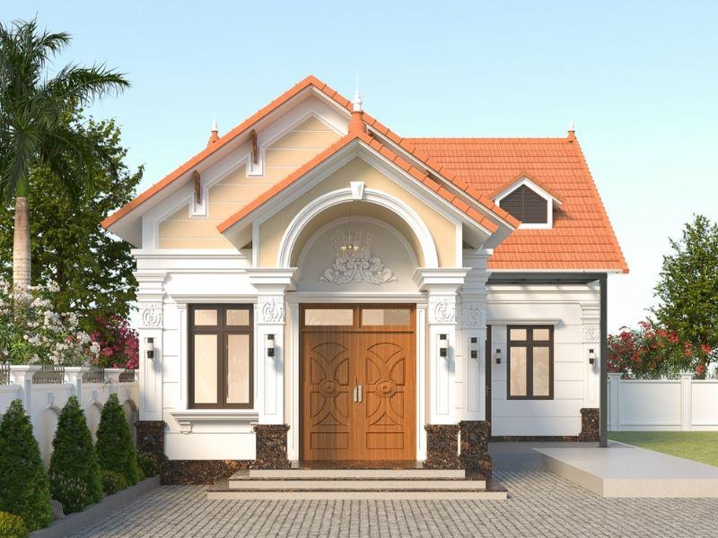 thiet-ke-nha-60m2-voi-tong-mau-vang-thu-thai Nhà cấp 4 mái thái màu cam nhạt với cửa gỗ và sân trước lát gạch, xung quanh là cây xanh tươi tốt.