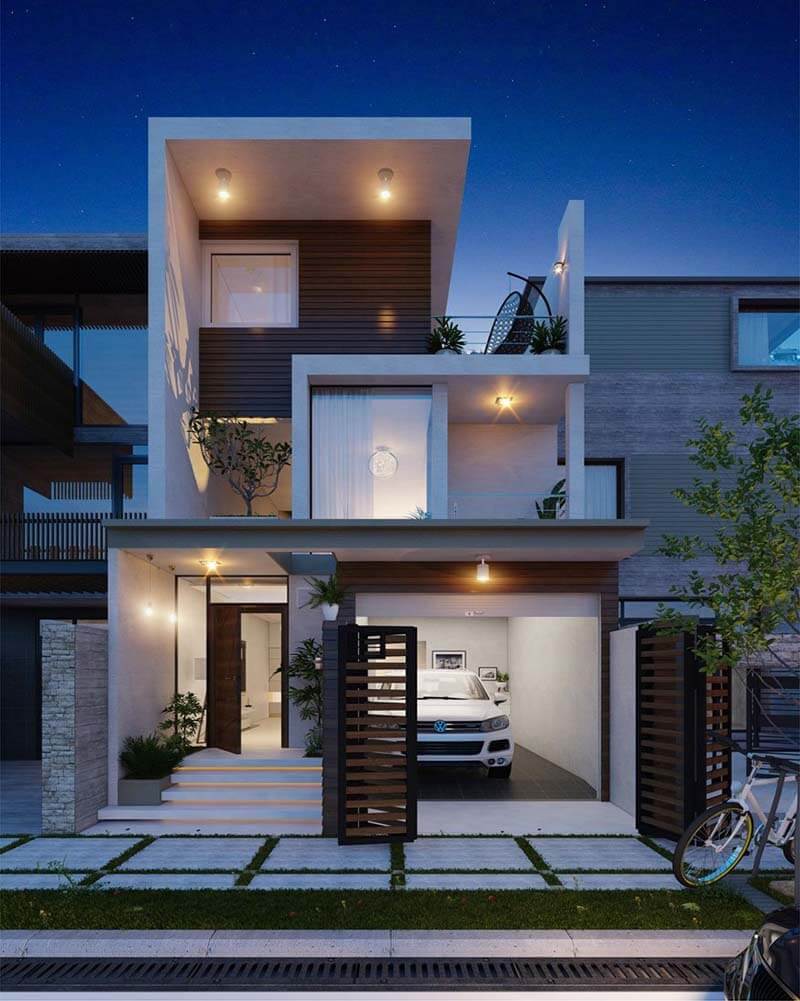 Nhà hiện đại 2 tầng với gara và ban công cây xanh được chiếu sáng vào ban đêm.