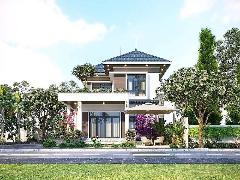 Nhà hiện đại 2 tầng với mái ngói xanh, sân vườn xanh mát và bàn ngoài trời, cảnh quan thiên nhiên.
