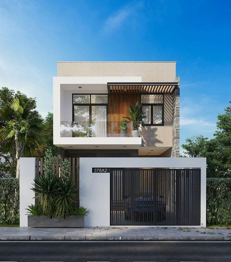 Ngôi nhà 2 tầng hiện đại với mặt tiền kính và cửa sắt, thiết kế tối giản và cây xanh xung quanh.