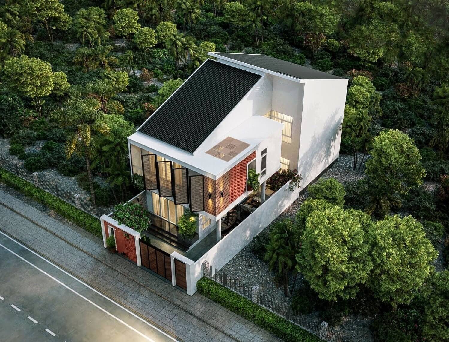 thiet-ke-nha-ngang-6m-dai-15m-co-gieng-troi-4 Nhà hiện đại với mái ngói đen, bao quanh bởi cây xanh, nằm cạnh con đường lát gạch rộng.