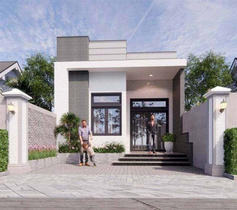 Nhà hiện đại một tầng với người đứng trước, xung quanh là cây xanh và hàng rào, bầu trời trong xanh.