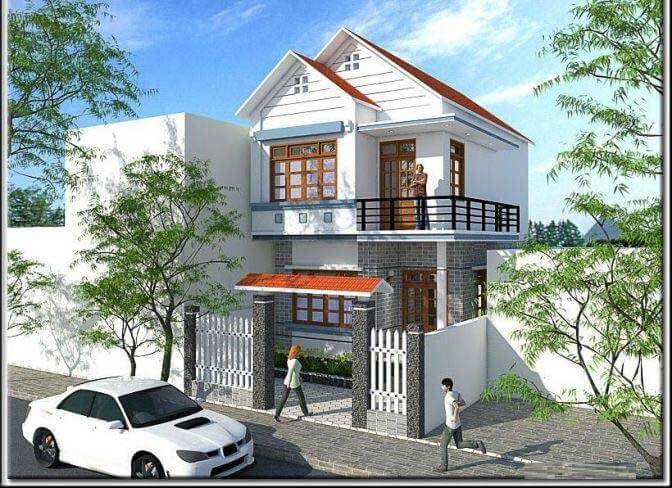 Nhà phố hai tầng hiện đại, mái ngói đỏ, ban công rộng, có cổng trắng, xe ô tô đỗ bên cạnh, hai cây xanh.