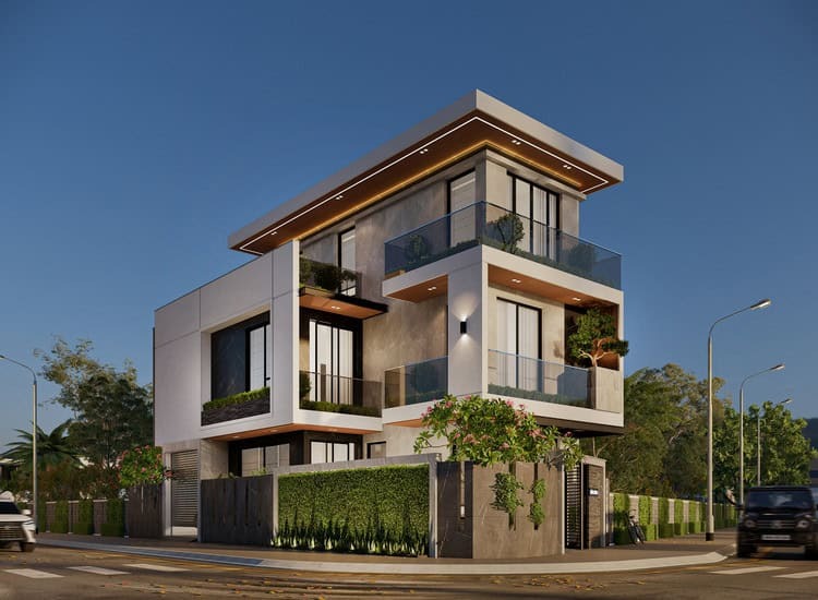 Ngôi nhà hiện đại ba tầng với ban công kính và cây xanh, nhìn từ góc đường vào buổi tối.