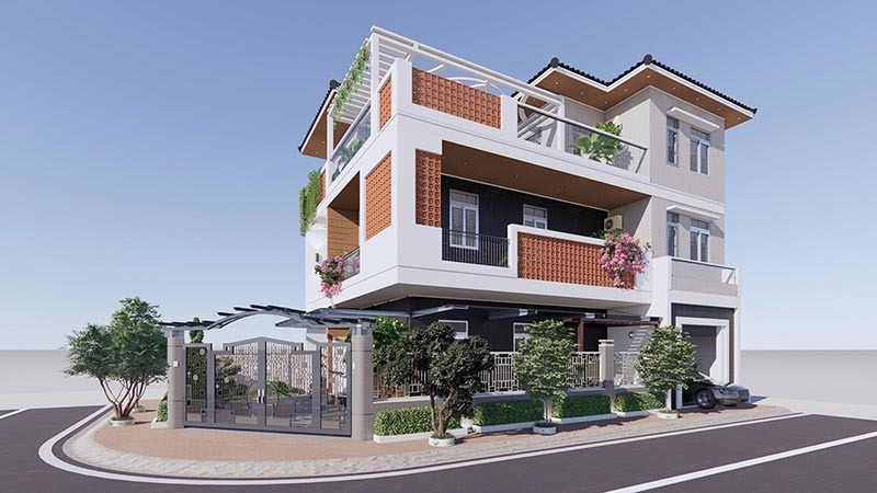 Nhà phố hiện đại ba tầng với ban công cây xanh, thiết kế mái ngói, nằm tại góc phố, ô tô đậu trước sân.