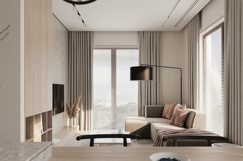 Phòng khách hiện đại với sofa góc, rèm cửa dài, đèn đứng và ánh sáng tự nhiên qua cửa sổ.