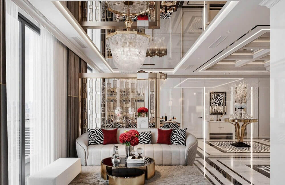 Phòng khách sang trọng với ghế sofa trắng, đèn chùm lớn và trang trí đỏ nổi bật.