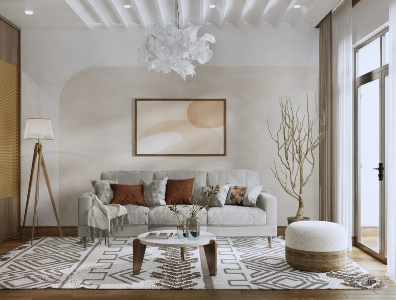 Phòng khách hiện đại với ghế sofa xám, tranh treo tường trừu tượng, thảm hoạ tiết, và ánh sáng tự nhiên.