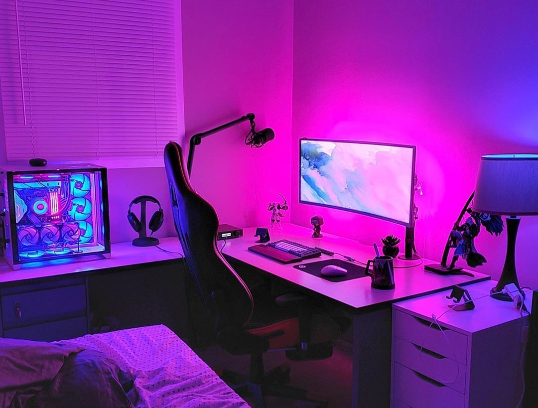 Không gian gaming RGB với máy tính cấu hình cao, màn hình lớn và ánh sáng neon hiện đại trong phòng tối.