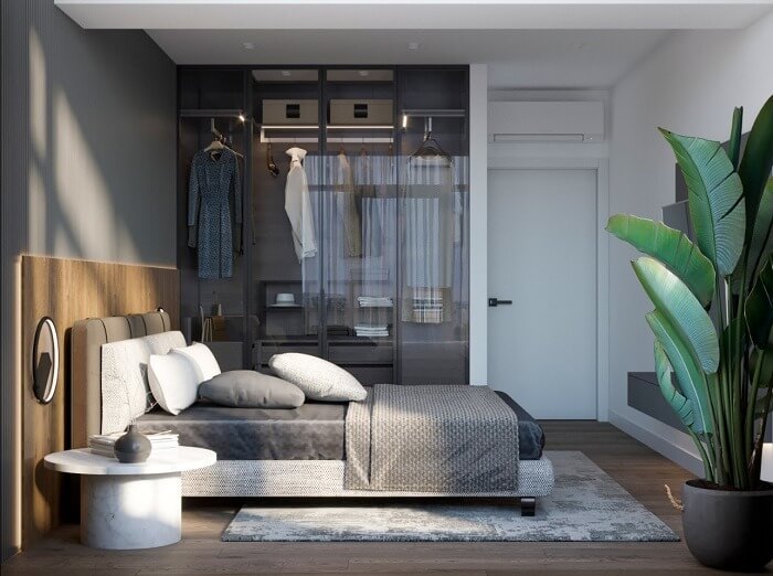 Phòng ngủ hiện đại với giường gỗ, tủ quần áo kính và cây xanh, ánh sáng tự nhiên tạo không gian thư giãn.