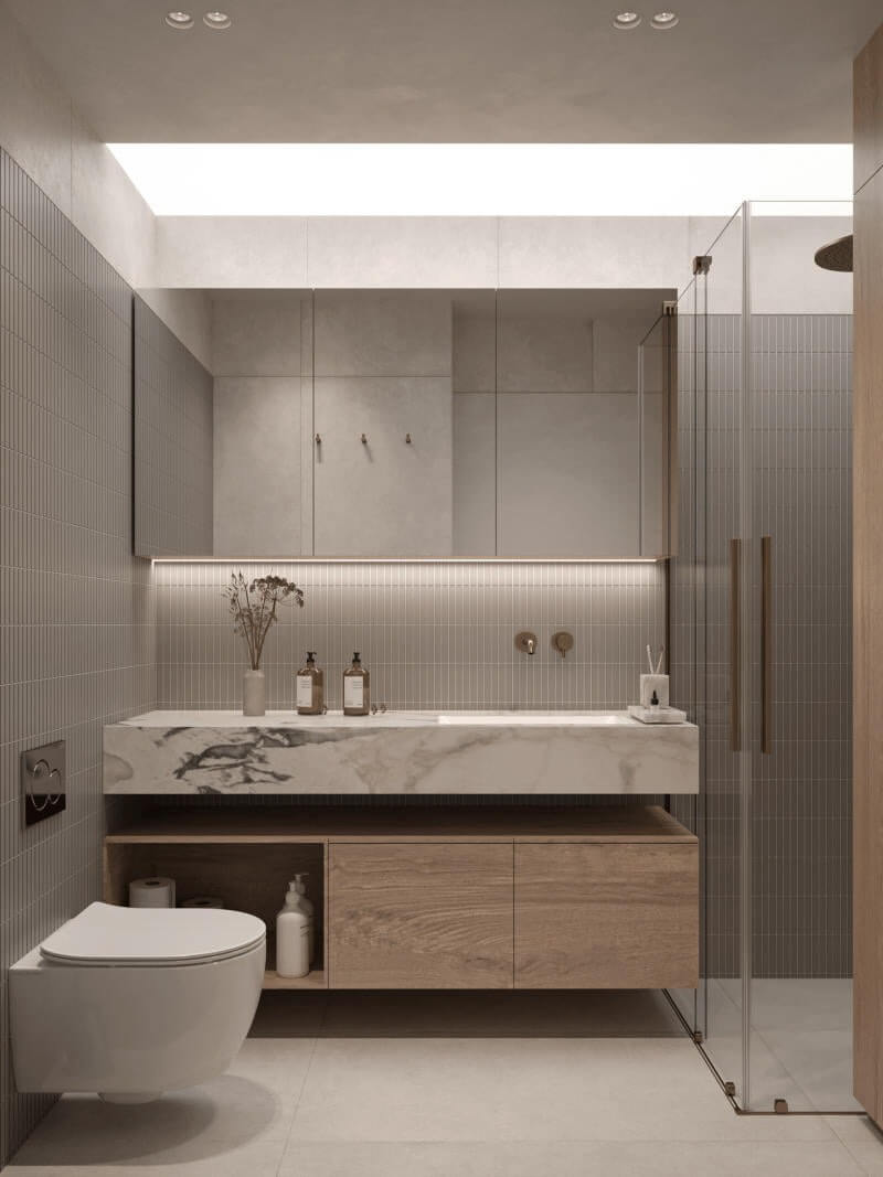 Phòng tắm hiện đại với lavabo đá cẩm thạch, nội thất gỗ và vòi hoa sen kính.