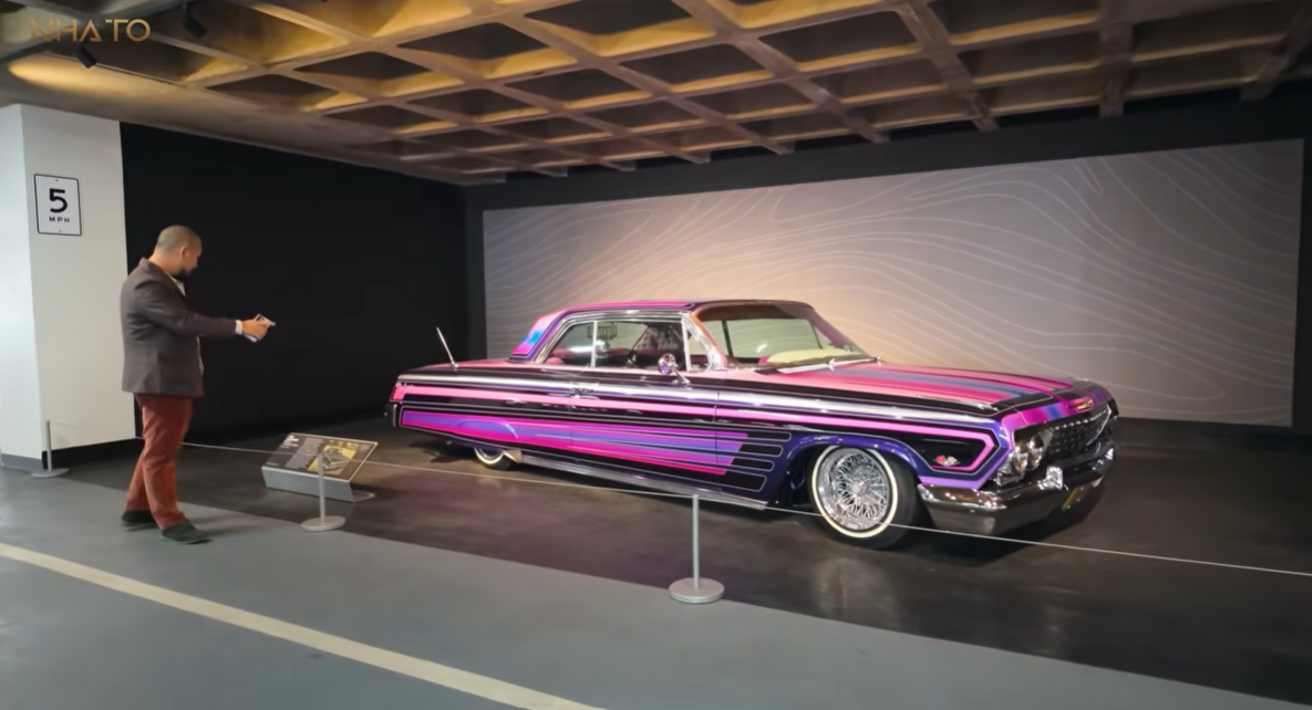 tlz-1 Xe hơi cổ điển độ với màu sắc nổi bật trong triển lãm, có người đang chụp hình.