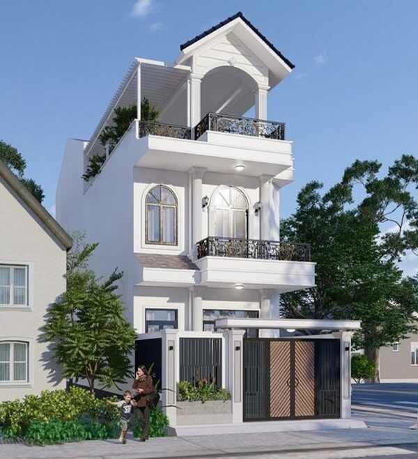 Nhà phố hiện đại ba tầng với cửa gỗ, ban công rộng và cây xanh xung quanh, trời xanh mây trắng.