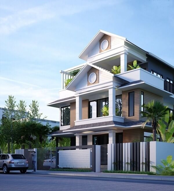 Nhà hiện đại ba tầng với cửa kính lớn và cây xanh xung quanh. Xe ô tô đỗ ngoài, bầu trời xanh trong lành.