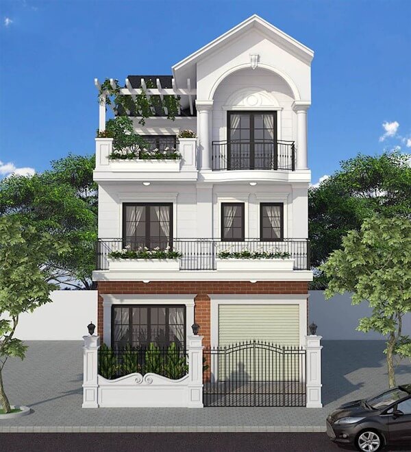 Nhà phố hiện đại ba tầng màu trắng, cửa sổ kính lớn, ban công thoáng đãng, cây xanh trang trí, mang tính thẩm mỹ cao.