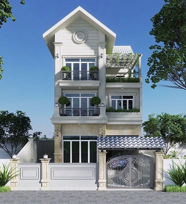 Nhà ba tầng hiện đại với cửa kính lớn và cây xanh, nổi bật dưới trời nắng xanh.