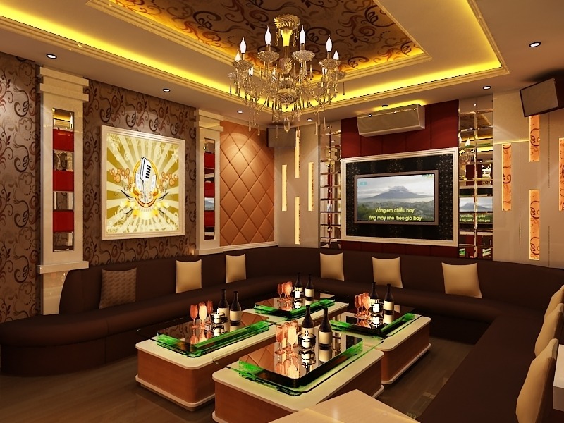 Phòng karaoke sang trọng với ánh sáng vàng, sofa đen, bàn kính và màn hình lớn.
