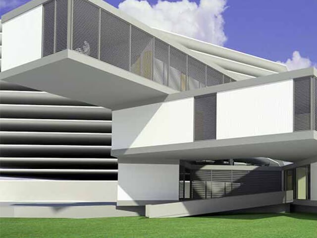 Tòa nhà hiện đại với thiết kế khối hộp độc đáo và sân cỏ xanh bên ngoài, bầu trời trong xanh.