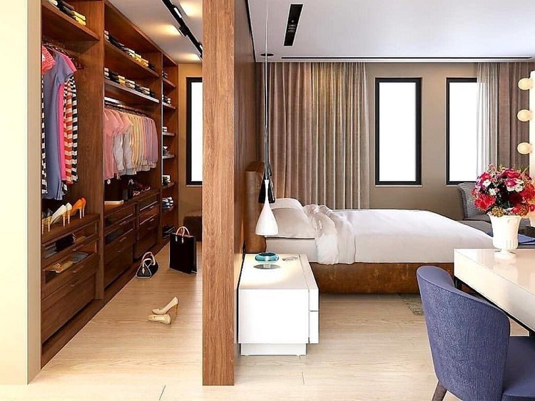 Phòng ngủ hiện đại với tủ quần áo mở rộng, giường nệm êm ái và bàn làm việc, ánh sáng tự nhiên.