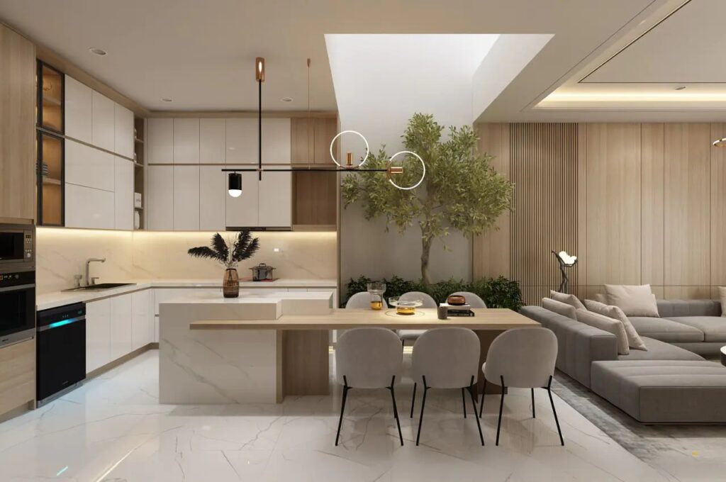 Phòng khách hiện đại với bếp mở, cây xanh trang trí và bàn ăn gỗ sáng màu.