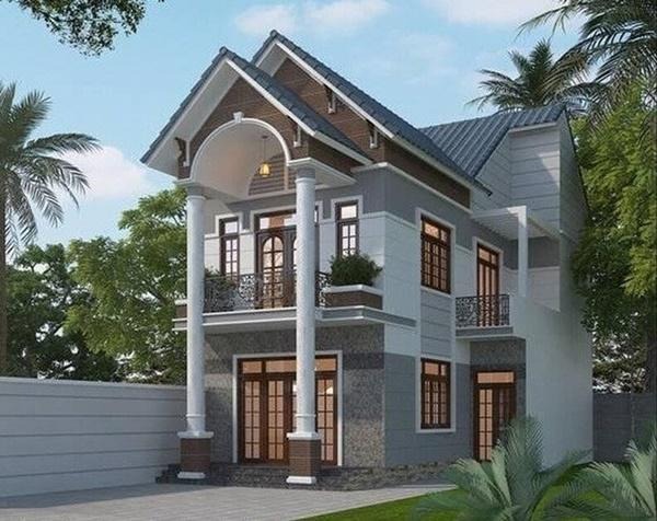 Nhà hai tầng hiện đại với mái ngói xanh, cửa kính lớn, cột trụ trắng, không gian xanh xung quanh.