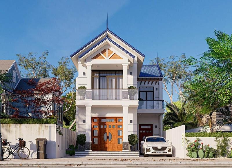 Nhà hiện đại hai tầng mái ngói xanh, có ban công và sân trước rộng với ô tô đỗ.