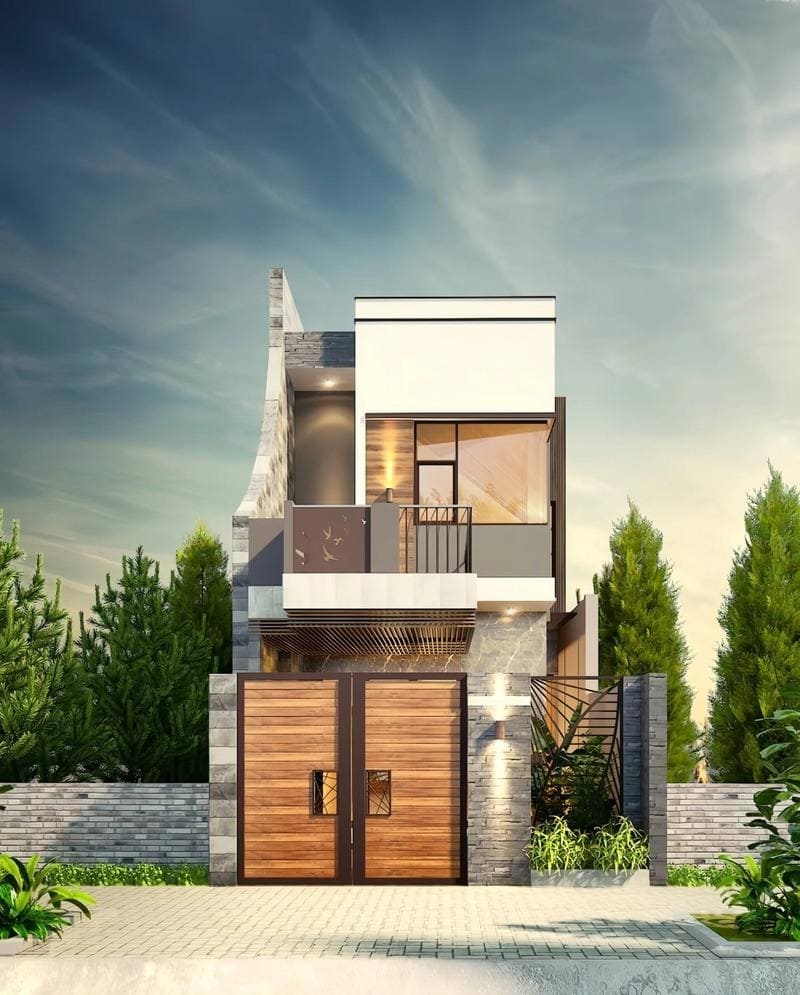 Mặt tiền nhà phố hiện đại với cửa gỗ và ban công, bao quanh bởi cây xanh dưới bầu trời trong xanh.