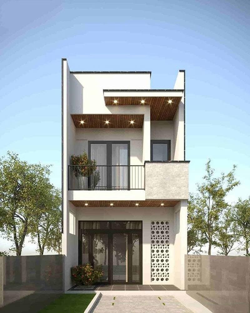 Nhà phố hiện đại 2 tầng với ban công và cửa kính lớn, cây xanh xung quanh dưới bầu trời trong xanh.